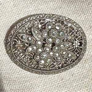 Classy antique sterling brooch with faceted floral design.